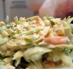 a close up view of a salad with lettuce and carrots in it