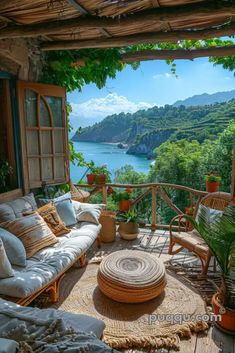 an outdoor living area with wicker furniture overlooking the water and hills in the distance