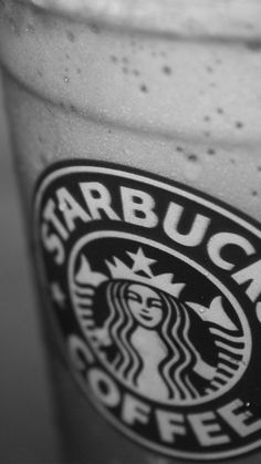 the starbucks logo is shown on top of a drink in a glass with ice and water