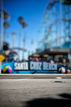 a skateboarder is riding down the street in front of an amusement park