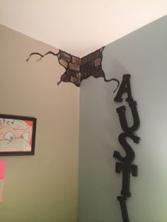 a metal sign that reads laugh hanging from the ceiling above a bed in a bedroom