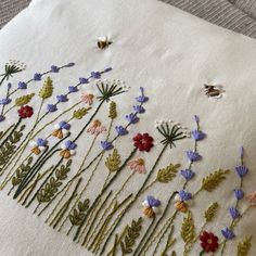 embroidered flowers and bees on white linen