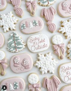 baby is for outside decorated cookies in pink and white with snowflakes on them