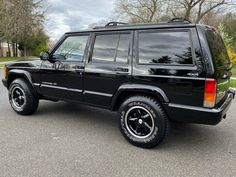 a black jeep is parked on the street