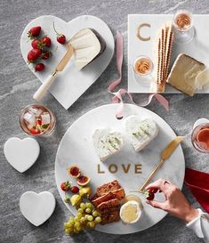 a plate with food on it that says love and is surrounded by other plates filled with desserts