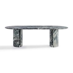 an oval marble table with two columns on each side and one column at the end