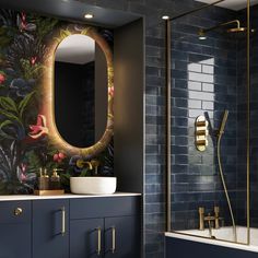 the bathroom is decorated in blue and gold with an oval mirror on the wall above the sink