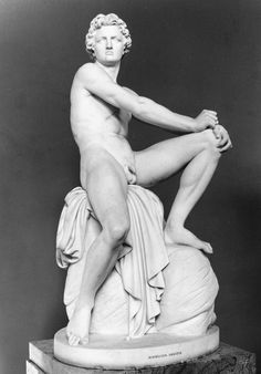 an old photo of a naked woman sitting on top of a marble statue in black and white