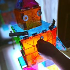 a person is playing with some kind of colorful cubes on the table in front of them