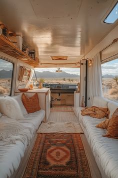 the inside of a camper with white couches and rugs on the floor