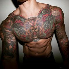 a shirtless man with tattoos on his chest