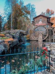 a water mill with a wreath on the fence