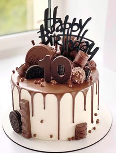 a birthday cake with chocolate icing and decorations