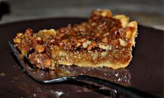 a piece of pecan pie on a plate with a fork