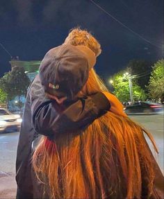 a person with long hair on the street