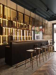 an empty bar with chairs and shelves filled with bottles