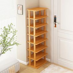 there is a wooden book shelf in the corner of this room with a white rug on the floor