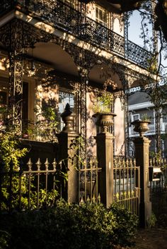 an iron fence and gate in front of a house