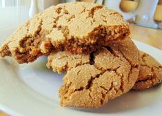 some cookies are on a white plate and one is cut in half to show the inside