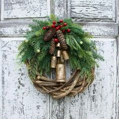 a wreath with bells hanging on the front door