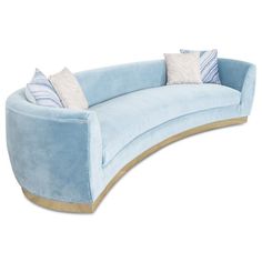 a blue curved couch with pillows on it