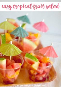 fruit salad in small cups with umbrellas on the top and text overlay that reads easy tropical fruit salad