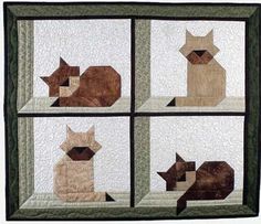 four cats are sitting in the window sill