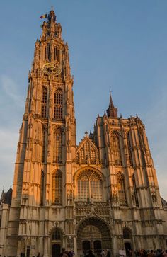 an old cathedral with people walking around it