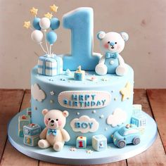 a blue birthday cake with teddy bears and balloons on the top is one year old