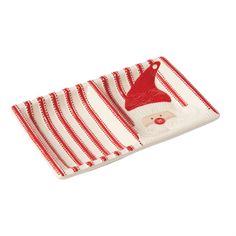 a red and white striped dish cloth with a santa clause on it