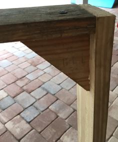 a piece of wood sitting on top of a brick floor