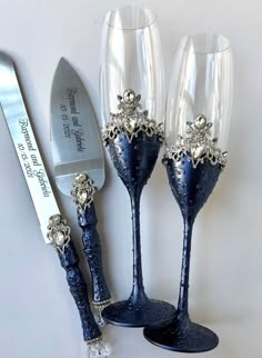 two wine glasses and a knife on a table