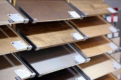 the shelves are filled with different types of wood flooring materials and labels on them