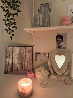 a white desk topped with a candle and pictures