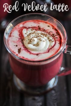 red velvet latte with whipped cream in a glass mug