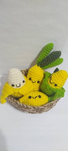 crocheted bananas and banana peels in a basket with faces drawn on them