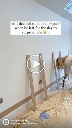 a woman is painting the walls in her house