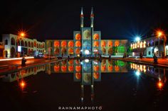 an image of a building that is lit up in the night time with lights on it