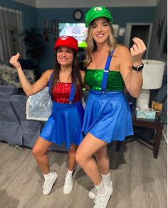 two women dressed in costumes posing for the camera