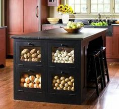 a kitchen island filled with lots of food on top of a hard wood flooring