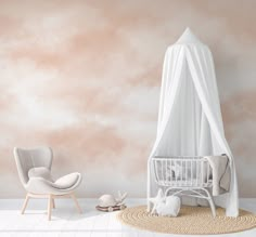 a baby crib in a room with pink walls and white furniture on the floor