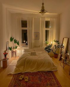 a bedroom with a large bed and lots of plants