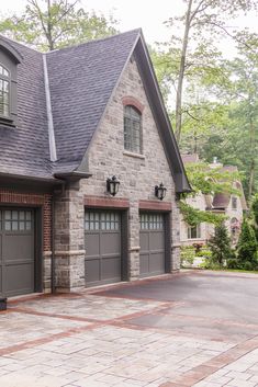 a large brick house with two garage doors