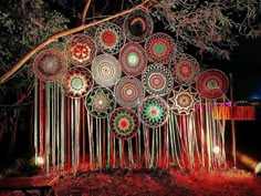 an artistic display with many umbrellas hanging from it's sides in the night