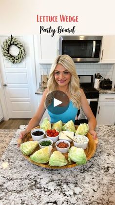 a woman sitting in front of a platter filled with food on top of a kitchen counter