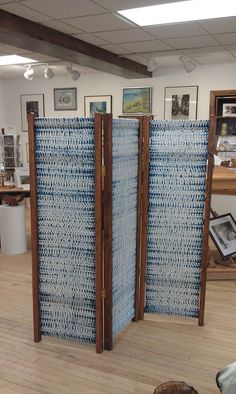 an open room divider sitting on top of a hard wood floor