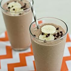 two glasses filled with chocolate milkshakes and banana slices