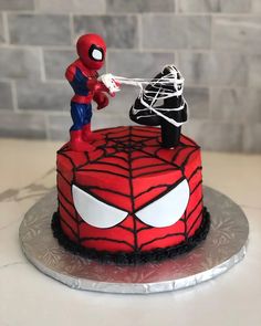 a spider - man cake is decorated with fondant and sprinkles