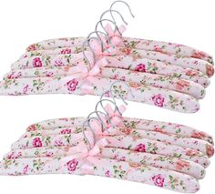 four pink flowers on white fabric hangers