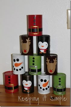 a stack of christmas themed cups sitting on top of each other in front of a white wall